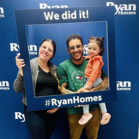 New Ryan Homes buyers celebrating with family and showcasing homeownership pride