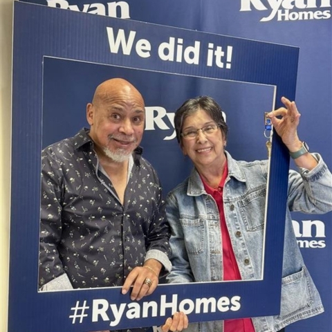 New homeowners celebrating their Ryan Homes purchase, holding keys